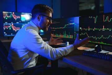 Crypto trader investor analyst looking at computer screen analyzing financial
