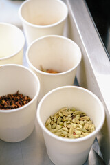 Cardamom spices for mulled wine in white paper cup. 