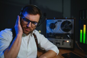 Secret agent listens on the reel tape recorder. Officer wiretapping in headphones