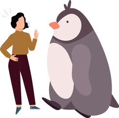 The girl stands next to the penguin.