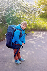 Cute school child, wearing big backpack, going for overnight sleep away from the family