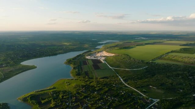 aerial view over duruitoarea quarry on the north of moldova during sunset at the prut river shore