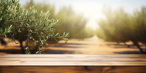 Mock up wooden table with green olive twig and blurry green outdoor background 