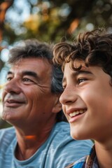 Fototapeta premium An older man and a young boy smiling at the camera. Suitable for family and generational concepts