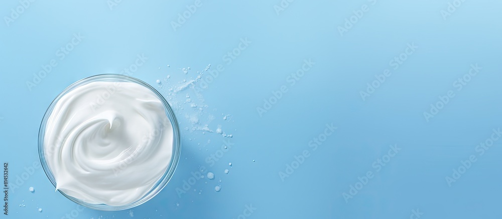 Aufkleber A delicious organic yogurt is displayed on a light blue surface with a top down perspective providing room for text in the image. with copy space image. Place for adding text or design
