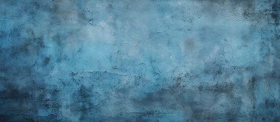 An abstract grunge background featuring a blue decorative plaster texture and a vignette providing ample copy space for design elements in the image