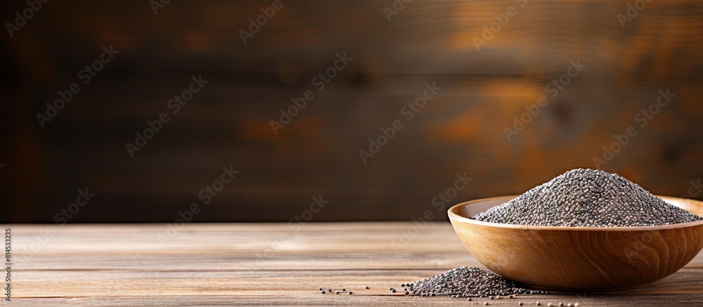 Poster Chia seeds in a bowl with a wooden background creating a copy space image