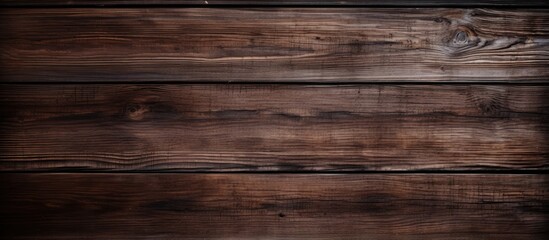 Fototapeta premium A copy space image of a rustic and earthy dark brown wooden background