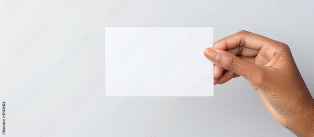 Poster a white prepaid card is held by a woman s hand against a white background with ample empty space for