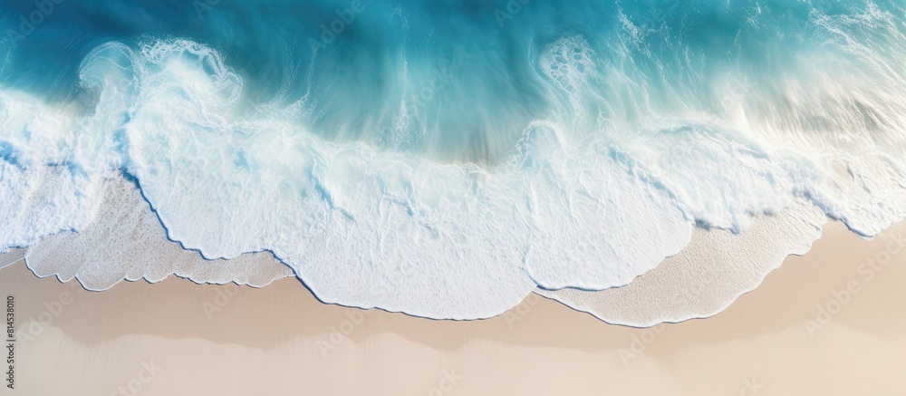 Poster a picturesque view of a sandy beach from above featuring light blue translucent waves and sun rays t