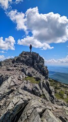 Fototapeta premium one hiker stands on summit of Borestone Mountain