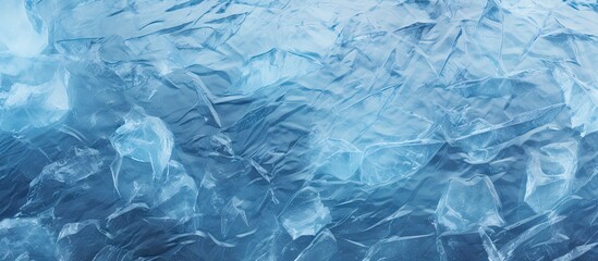 Obraz premium Winter nature background featuring the stunningly patterned transparent dark blue ice of frozen Baikal Lake adorned with elegant white cracks The image offers plenty of copy space
