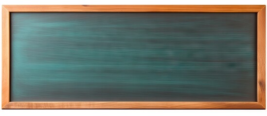 A blackboard and pencil made of wood are positioned alone on a white background allowing for a copy space image
