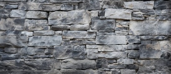 A closeup front view of a textured old stone wall serves as a background offering a copy space image