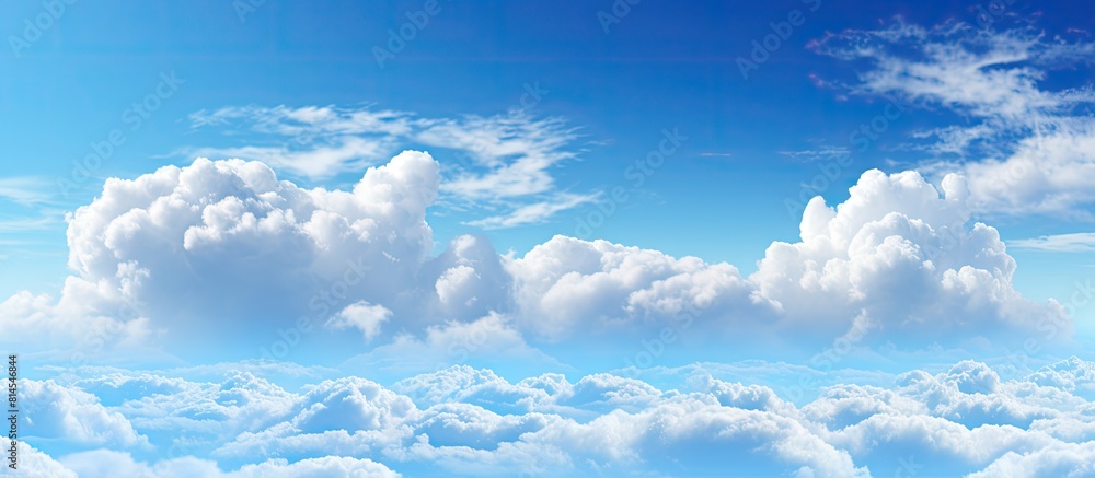 Aufkleber The spacious blue sky is adorned with large billowing white clouds creating an ideal copy space for adding text