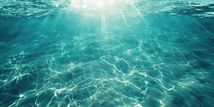 Sunlight shining through the clear blue ocean water, ideal for nature and marine themed designs