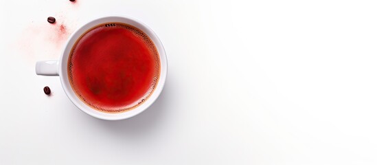 Top view of a red ceramic cup filled with steaming aromatic coffee on a white background Perfect for a copy space image