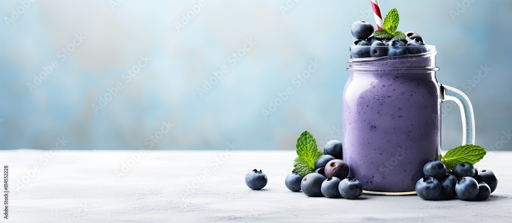 Poster a fresh blueberry smoothie is presented in a mason jar on a white table creating a visually appealin