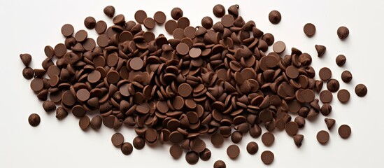 The image shows a heap of chocolate chips or drops arranged separately on a white background providing ample space for copying
