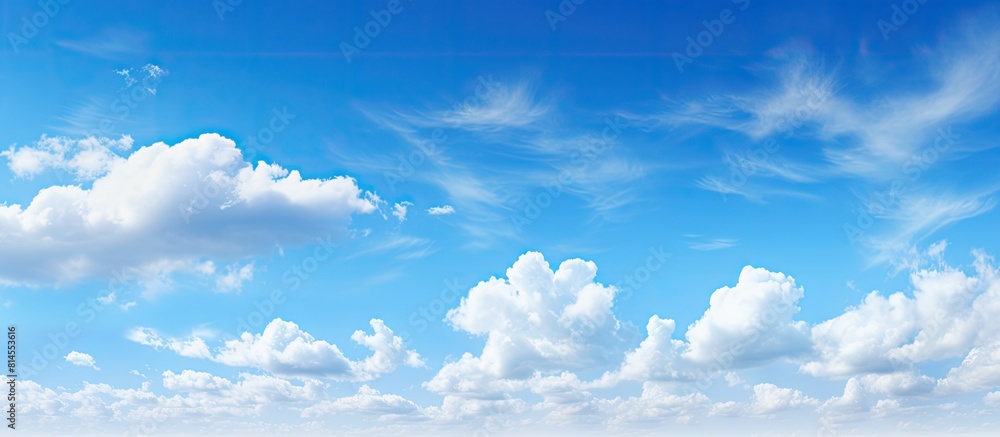 Aufkleber a peaceful summer scene with a clear blue sky adorned by fluffy white clouds offering plenty of spac