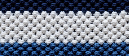 A textured hand knitted yarn cloth in different shades of blue and white creating an abstract background with a garter stitch pattern Includes a close up copy space image