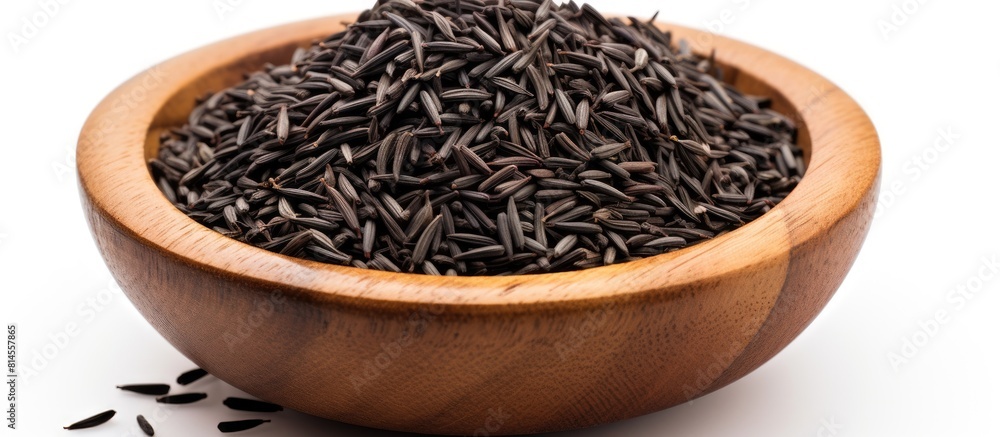 Leinwandbilder copy space image of black cumin seeds presented in a wooden bowl isolated on a white background the 