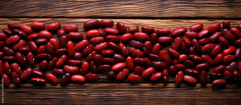 Poster a warm toned copy space image of numerous red beans arranged on an aged wooden surface as seen from 