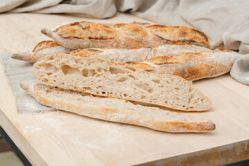 Homemade Italian ciabatta bread cut on the table