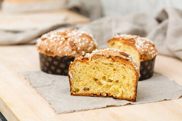 Homemade muffin with nuts and raisins in a cut on the table