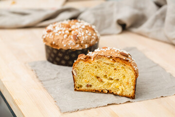 Homemade muffin with nuts and raisins in a cut on the table