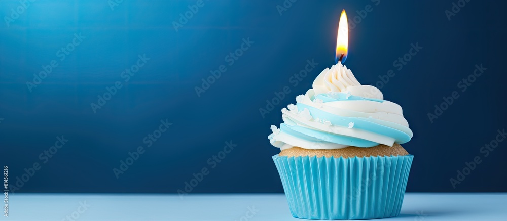 Poster a festive cupcake with vibrant candles set against a vivid blue backdrop with ample copy space for i