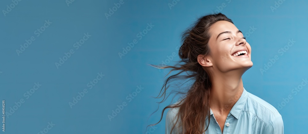 Poster copy space image of a joyful and beautiful girl showcasing a solution isolated on a vibrant blue bac