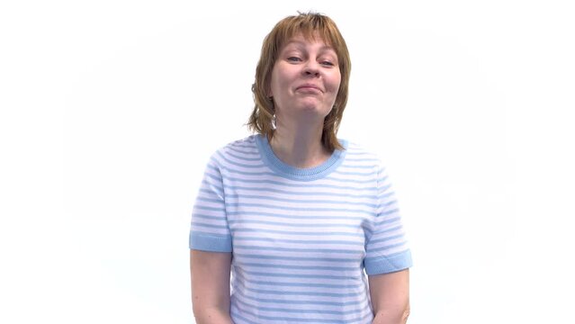 A young woman displays arrogance by arrogantly turning her nose up and looking down haughtily. White background.
