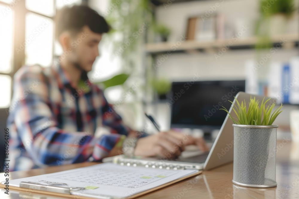 Poster man sitting at desk using laptop. suitable for business and technology concepts