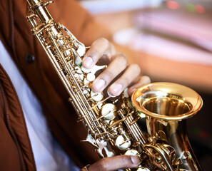 Person, musician and hands with saxophone by house, talent and practice as band for jazz music as...