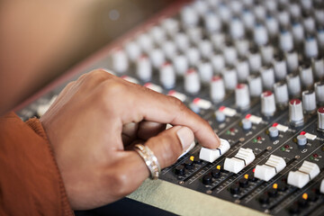 Hand, music producer and audio mixer in studio for volume level, frequency content and dynamic....