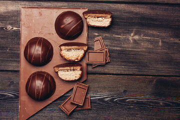 delicacy made of chocolate bars and pastries on wooden background texture dessert