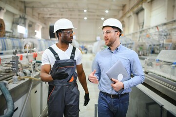Two Heavy Industry Engineers Stand in Factory