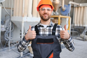 Portrait of factory worker. Young handsome factory worker