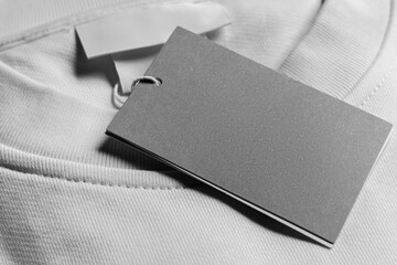 Close-up of a blank tag on white clothing. Resource for mockup design.