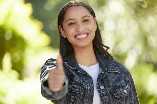 Portrait, woman and happy in outdoor, thumbs up and opportunity at university, campus or college as student. Female person, candidate and vote for leadership in school as representative in election - Powered by Adobe