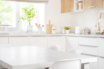Empty dining table with chairs in modern kitchen furniture interior of pastel color