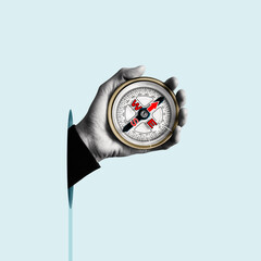 Compass in a humans hand. Business development in the right direction. Art collage.