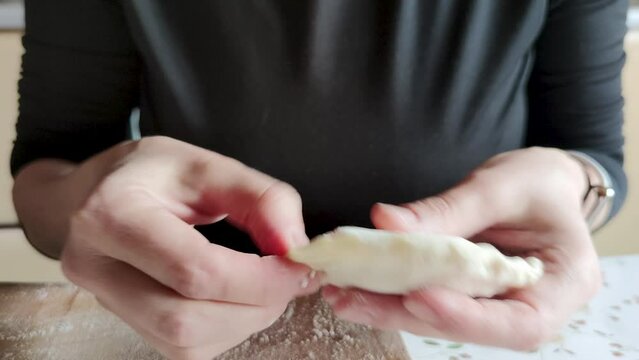 Close-up hands cooking dumplings dough
