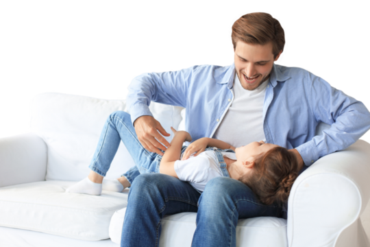 Smiling young father lying on couch at living room and play with happy little daughter on a transparent background