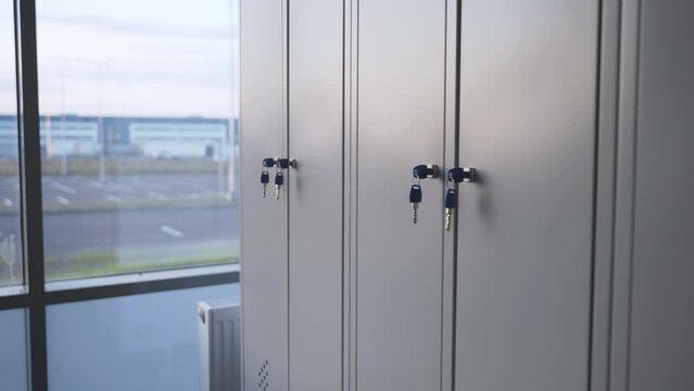 Lockers arranged in row create sense of orderliness in locker room. Lockers equipped with sturdy locks to ensure safety of personal items