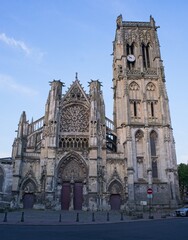 Fototapeta premium Dieppe, France - May 10, 2024: Cathedral. People walking in the city of Dieppe. Streets and buildings. Lifestyle in the urban area. Sunny spring day. Selective focus