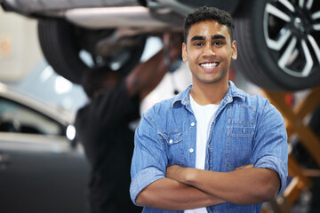 Portrait, man and smile as mechanic in automobile, workshop and repairs with confident or pride as...
