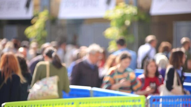 People walking in line at event entrance &ndash; close-up through barrier