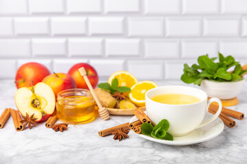 Fragrant hot tea with cinnamon stick and anise on a textured wooden background. A cup of hot tea...